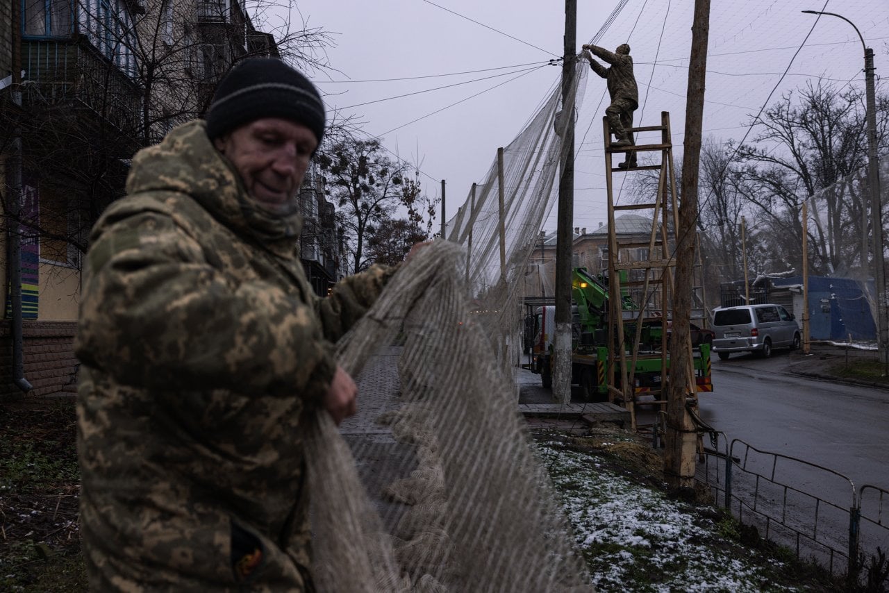 Members of the Ukrainian Armed Forces install anti-drone nets in the city centre of Izyum, Ukraine, this week.